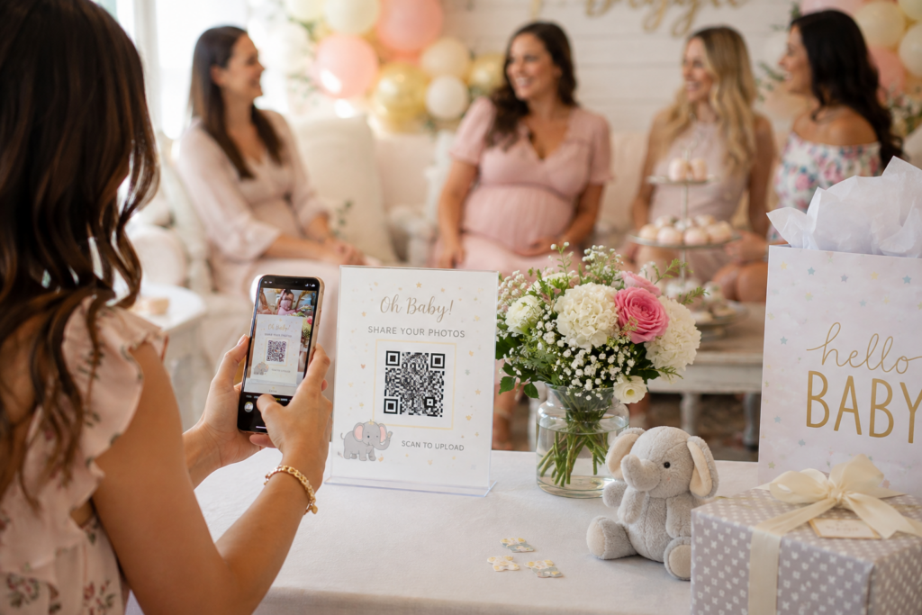 Guest scanning a QR code at a baby shower to upload event photos